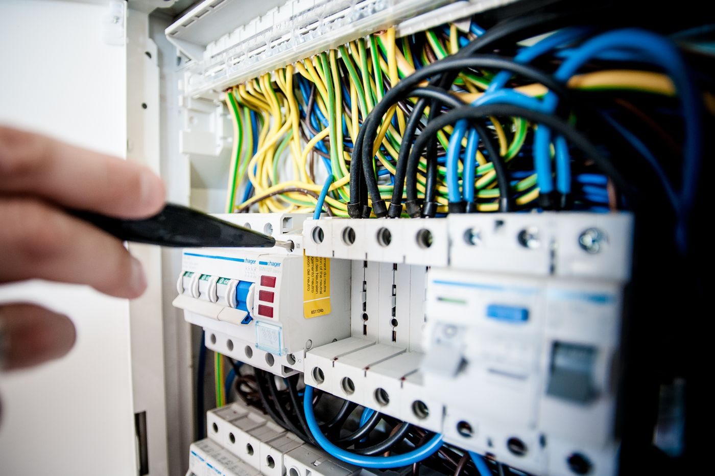 Technician checking control wiring and electrical components for an irrigation timer